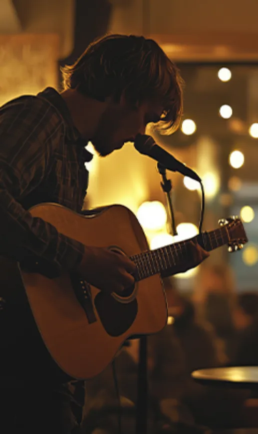 A guitarist performing an acoustic live session at The Grog